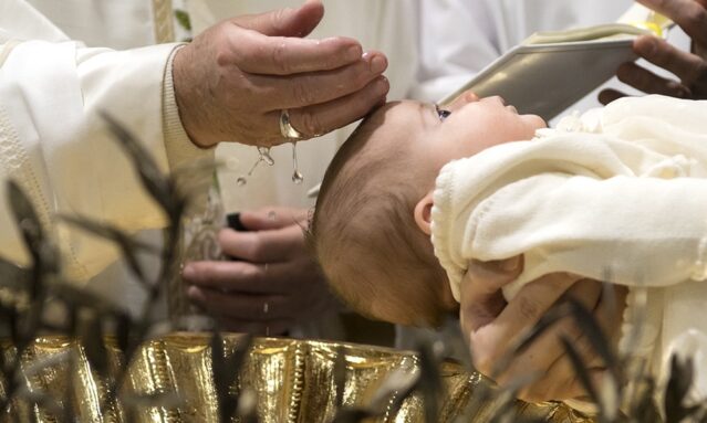 Pope Francis baptizes one of 28 babies in the Sistine Chapel at the Vatican Jan. 8. (CNS photo/L'Osservatore Romano, handout) See POPE-BAPTISM Jan. 9, 2017.